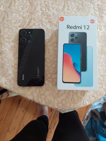 батарея на телефон fly bl6425: Redmi 12 modeli, qara rəngdə və orijinal qutusunda təqdim olunur. Bu — 1