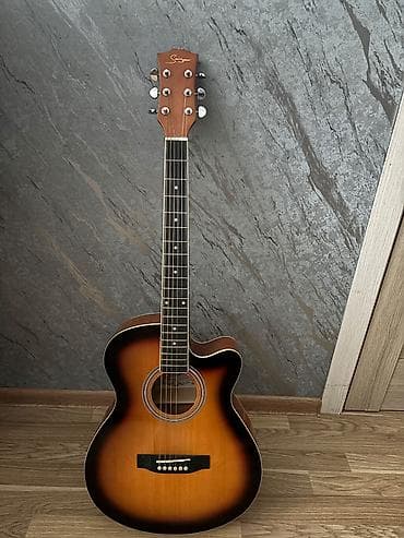 gitara simi: Sniker firmasına aid akustik gitara,alan olsa üstündə çantada — 1