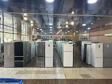 Məişət texnikası mağazasında müxtəlif model və ölçülərdə soyuducu