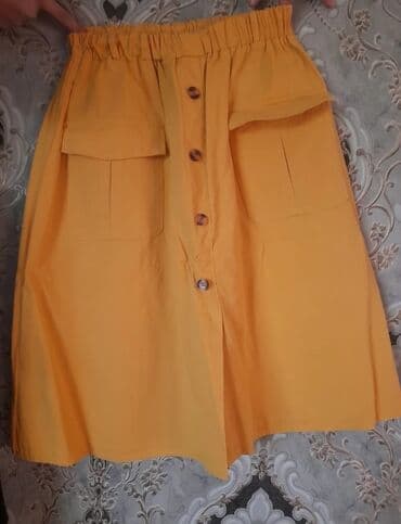 Sarı rəngli qadın ətəyi - Model: A-kəsimli, dizə yaxın uzunluq -