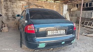 ucuz motolar: Audi A6 sedan təqdim olunur. Avtomobil tünd rəngdədir, 4 qapılı кузов — 2