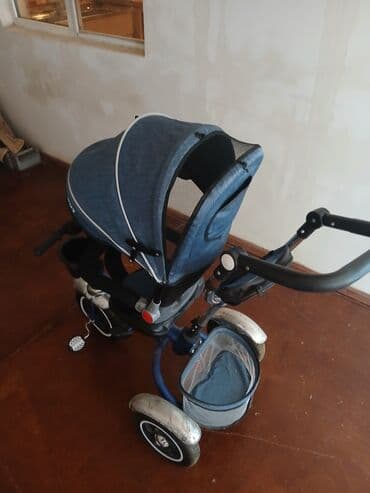 Uşaqlar üçün tünd göy rəngdə nəzarət qolu olan üçtəkərli velosiped. Bu