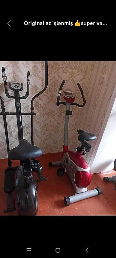 İki ədəd idman avadanlığı: biri qara rəngdə elliptik trenajor, digəri