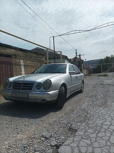 vaz lada oka: Mercedes-Benz E‑Class (W210) sedan – gümüş rəng. 1998 çi il 2.2 — 6