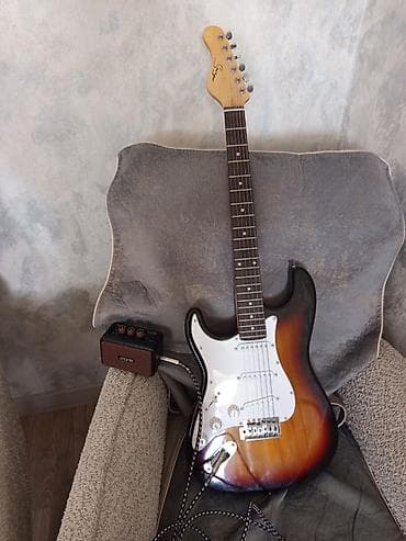Şəkildə gördüyünüz Smiger elektro gitarı və yanındaki amfini satıram