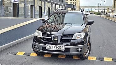qara maşın: Mitsubishi Outlander – şəhər və yolsuzluq üçün praktik krossover. - — 1