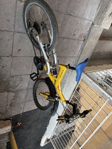 горный велосипед: Sarı rəngli qatlanan şəhər velosipedi Xüsusiyyətlər: - Qatlanma — 6