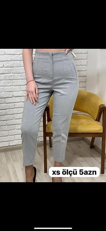 Qadın şalvarı – boz rəng, yüksək belli, dar kəsim. Detallar: ön