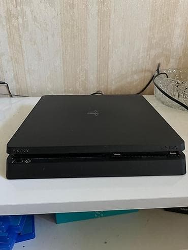 4 4: Sony PlayStation 4 Slim oyun konsolu Paketə daxildir: - PS4 Slim — 2
