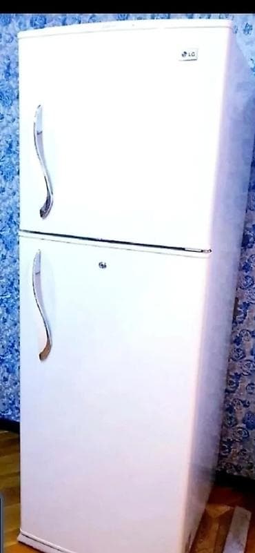 Boz rəngdə, iki bölməli soyuducu. Yuxarı hissə soyuducu, aşağı hissə