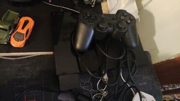 disklərin satışı: Sony PlayStation 2 Slim (PS2) oyun konsolu paketi Daxildir: - PS2 — 4