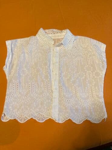 qarin eritmek ucun krem: Bu ağ rəngli, qolsuz bluz yaraşıqlı naxışlı dizayna malikdir. Bluzun — 1