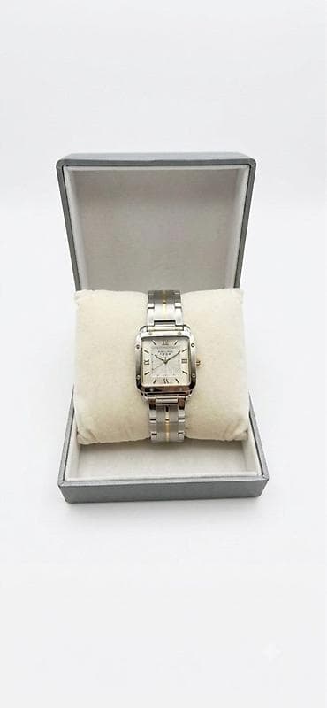 pandora qutu: İki rəngli (gümüş/qızılı) metal korpus və qolbaqlı kvadrat formalı — 2