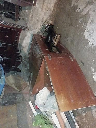 Klassik ayaqla idarə olunan tikiş maşını və taxta stol - Mexaniki