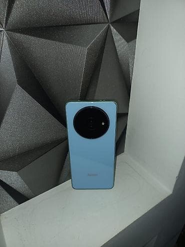 Redmi smartfon. Cihaz açıq mavi rəngdədir və arxa hissəsində böyük lalafo.az -da Redmi smartfon. Cihaz açıq mavi rəngdədir və arxa hissəsində böyük