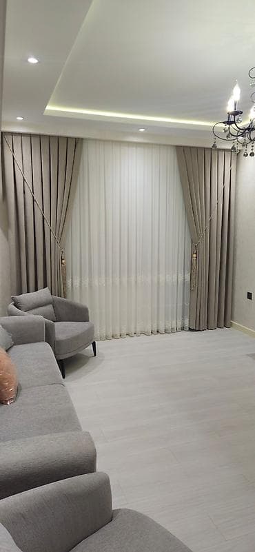 Bej rəngli, sıx toxunmuş qalın pərdələr və ağ, tül pərdələr dəsti