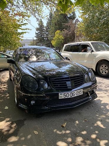 mercedes c190: Mercedes-Benz E‑Class (W211) sedan – qara rəng, AMG üslublu eksteryer — 3