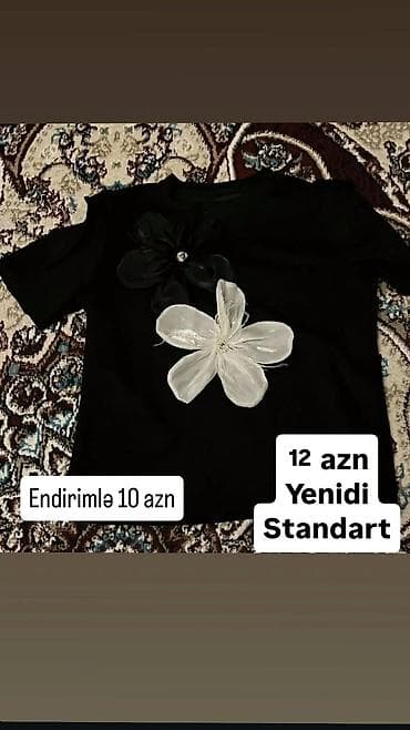 Qara rəngli qısaqoll köynək. Ön hissədə biri qara, biri ağ olmaqla iri lalafo.az -da Qara rəngli qısaqoll köynək. Ön hissədə biri qara, biri ağ olmaqla iri
